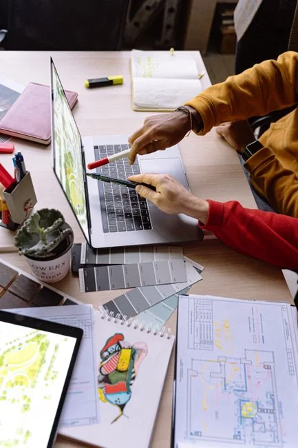 A modern computer screen displaying web design work, showcasing creative visuals in a workspace.